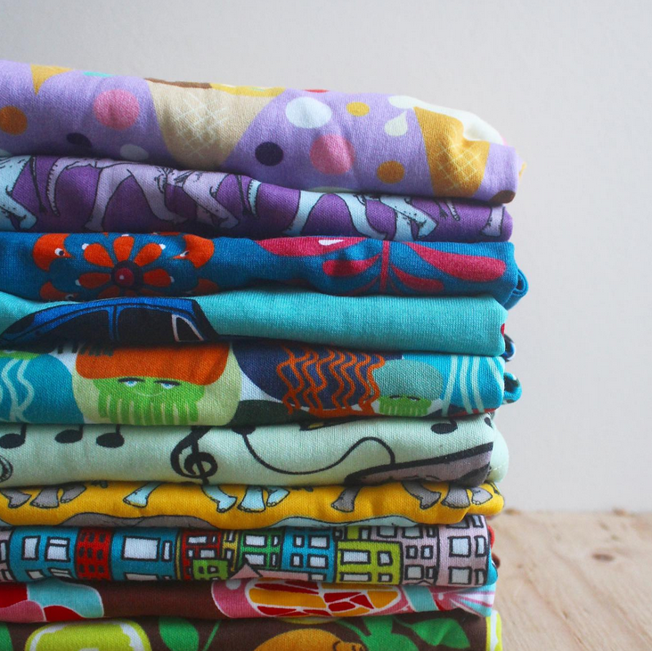 Stack of printed clothing from notjustvisualphotobooths