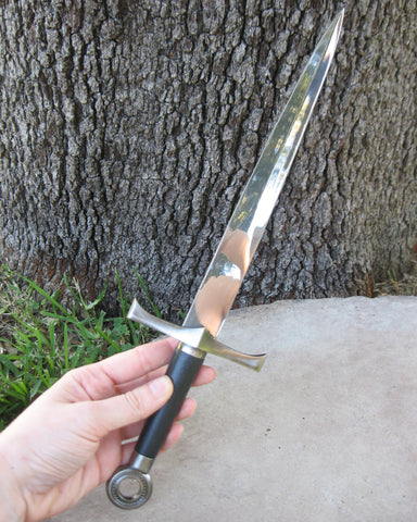 Holding a black-handled athame