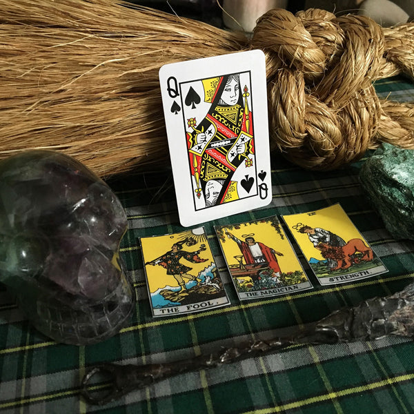 Tarot card reading with wand and crystals