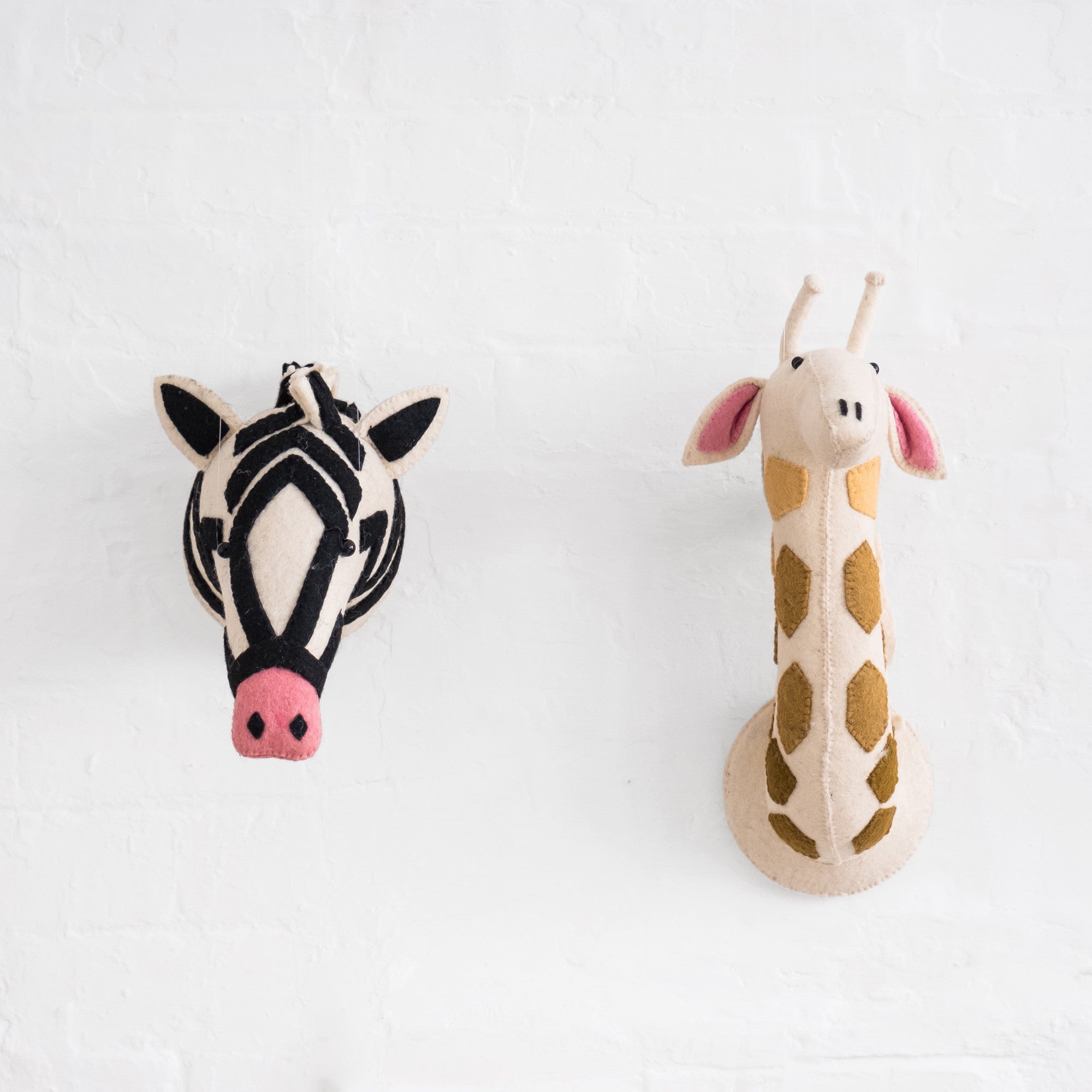 Felt Zebra Head and Felt Giraffe Head by Fiona Walker England, available at Bobby Rabbit.
