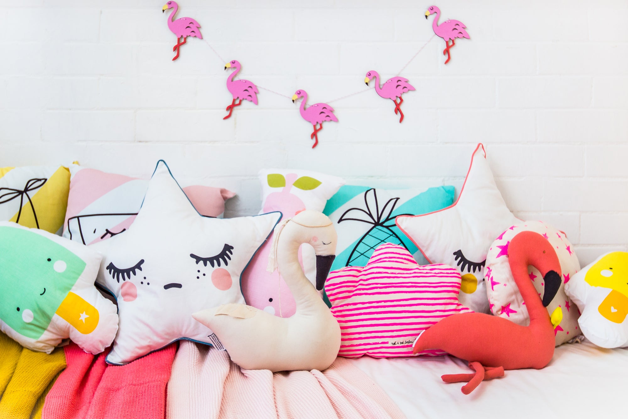 Cushions and Flamingo Garland, all available at Bobby Rabbit (room styling by Bobby Rabbit).
