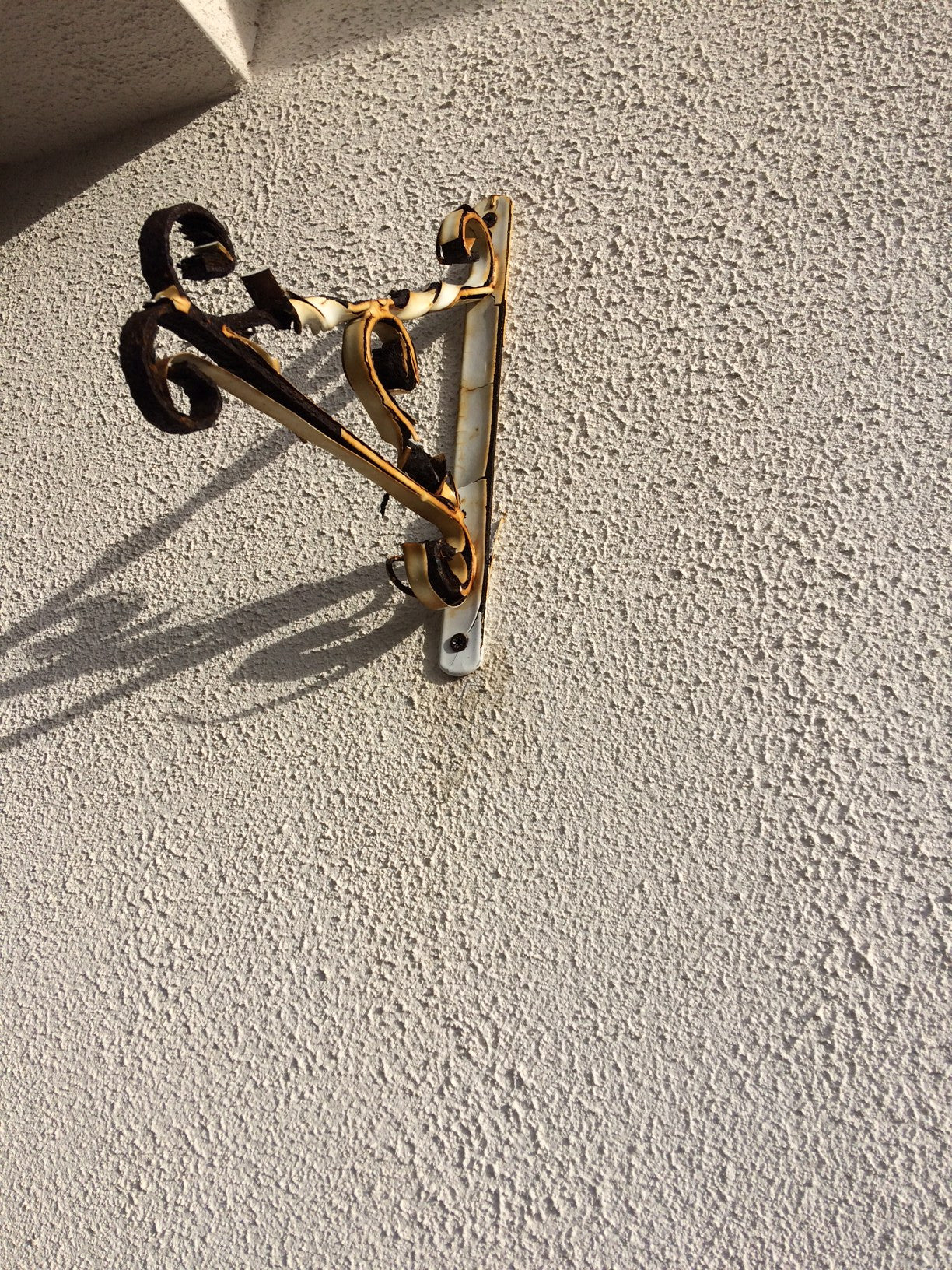 Clean rust from render caused by hanging basket bracket