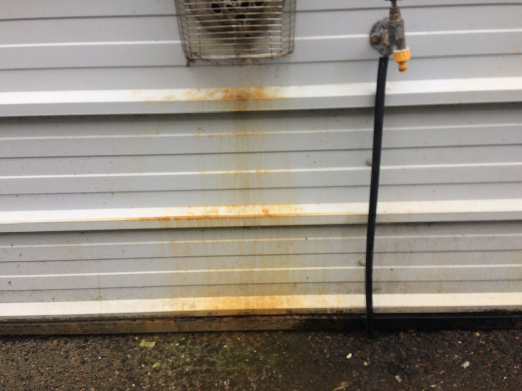 Remove rust stains from steel cladding
