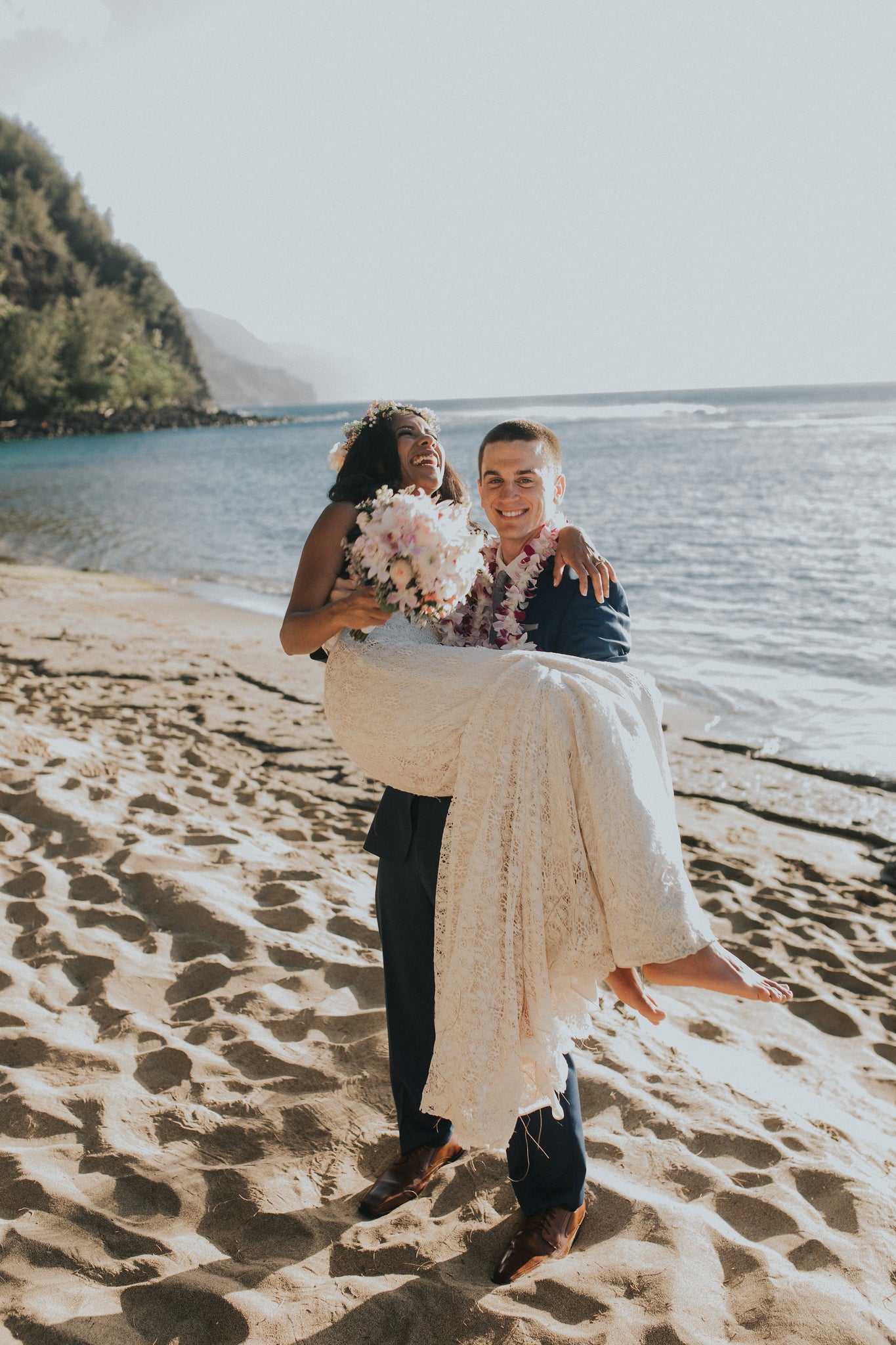 Groom carries his Wife along the beach!