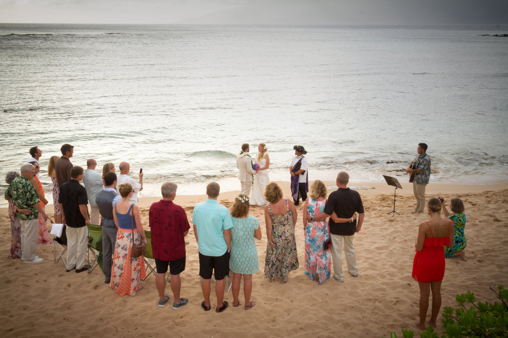 Bride and Groom surrounded by Friends and Family on Beach in Maui, Hawaii
