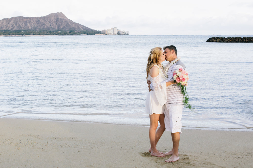 Bride and Groom Kiss on Duke Kohanamoku Beach in Waikiki, Oahu, Hawaii
