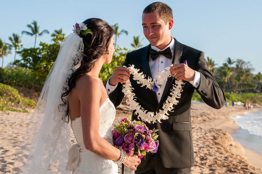 A Groom places a Hawaii Traditional Lei on his Bride