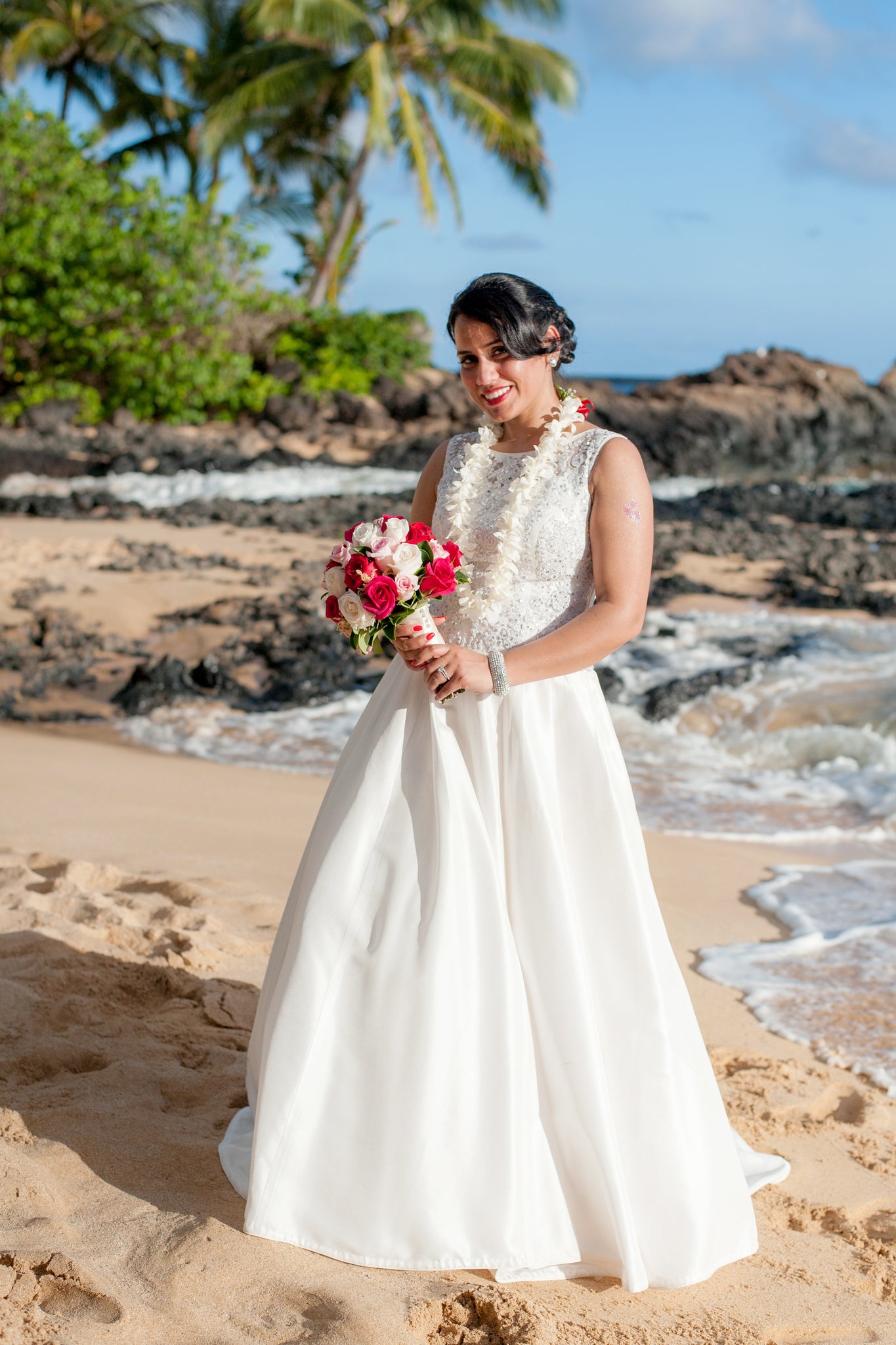 Bride poses on a beach in Maui, Hawaii