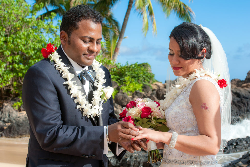 Groom places ring on his Brides finger in Maui, Hawaii