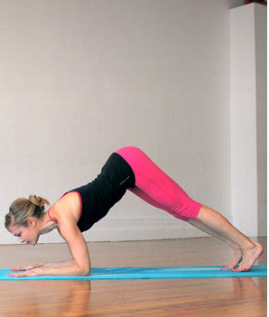 woman in plank pose with butt in air creating a v-shape