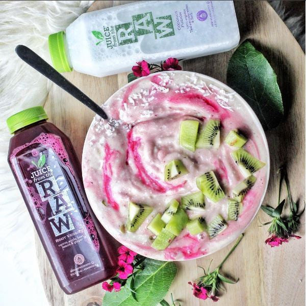 bowl of ice cream and fruit juice bottles surrounding it