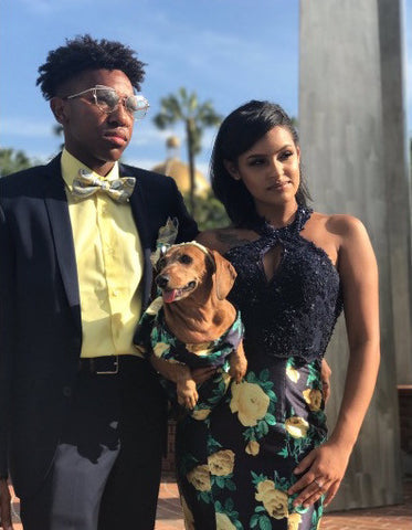 girl posing with prom date & dog with matching prom dress