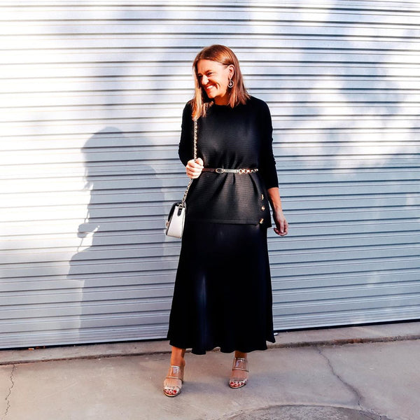 Jasmine wearing our Deborah midi satin skirt with a black tee and belt 