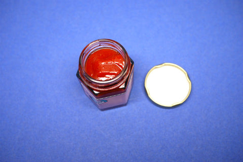 Weak Knees Gochujang Sriracha Hot Sauce in a small jar
