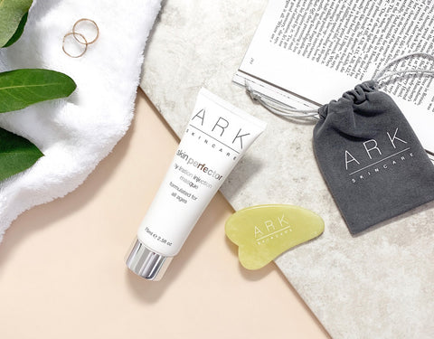 ARK Skincare's Jade tool with a grey pouch and how-to guide