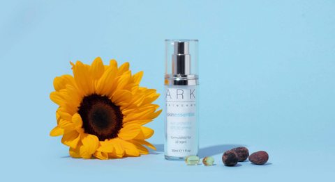 ARK Skincare's SPF 30 Primer laid next to a sunflower