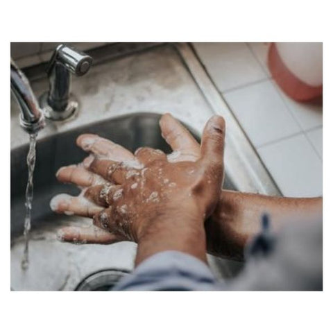 Image: Person lathering their hands up with soap at a sink