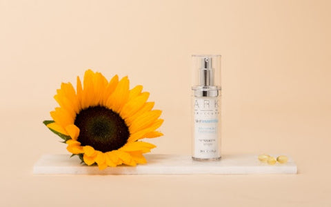 ARK skincare's SPF 30 Primer laid next to a sunflower