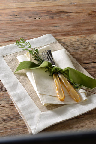 Place setting on wooden table with green ribbon