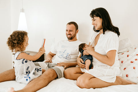 Parents and children in a bed at home via unsplash