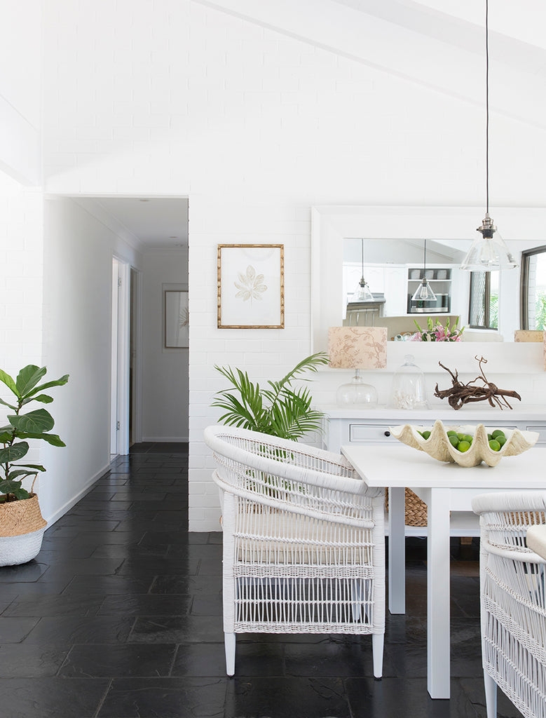 Hampton style dining room with rattan chairs and black floors kerri shipp driftwood interiors