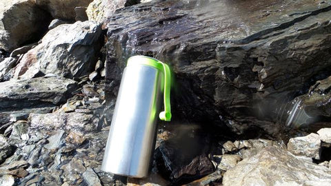 water-purifier-bottle-in-use-with-spring-water-french-alps