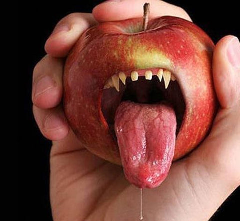Scary apple with teeth and tongue