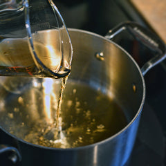 Pour the rye into a medium saucepan over high heat.