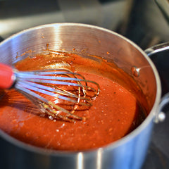 add the ketchup, tomato paste, molasses, vinegar, mustard, and hot sauce, if using. Whisk until smooth.