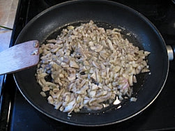 Cook mushrooms in a frying pan until soft