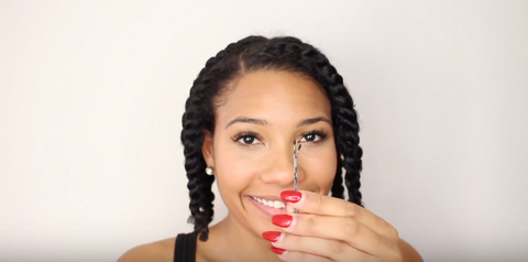 Step 7: Use a pin to hold your twists back so they aren’t in your way too much while you’re letting the style sit.