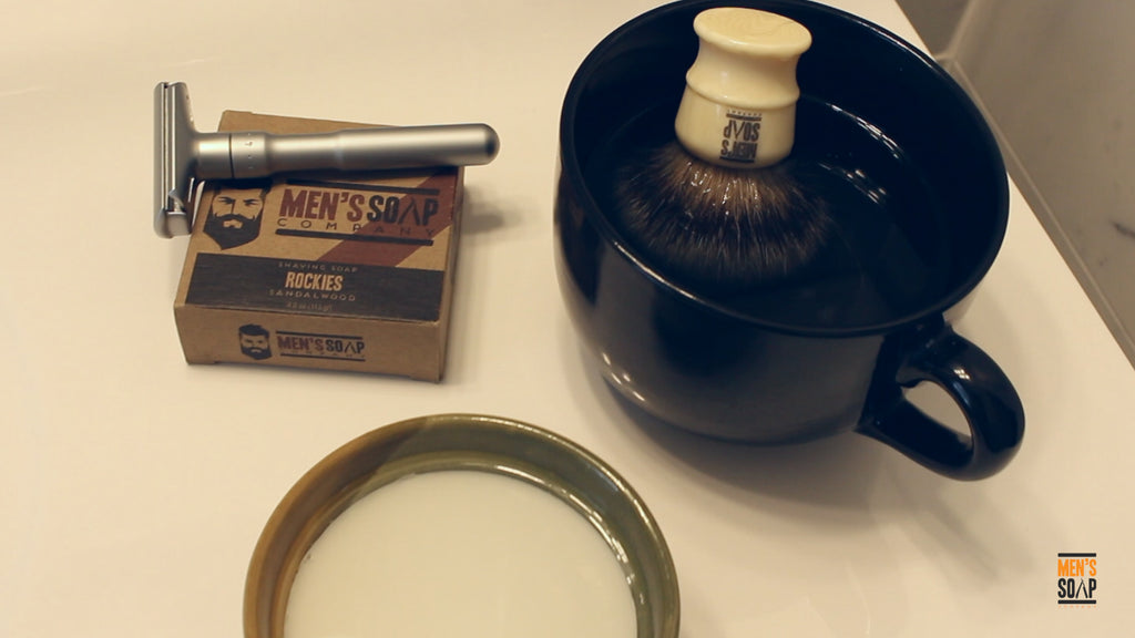 Shaving soap and shaving brush soaking in warm water.