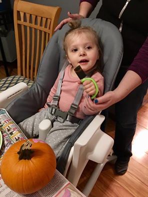 Kyla paiting a pumpkin using EazyHold universal cuff