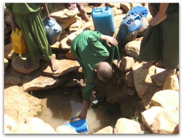 Ethiopian girls fetch water from a catchment