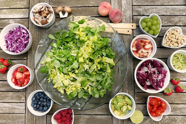 fruits and leafy vegetables on the bowls