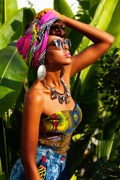 model posing in colourful African tribal print headpiece, boob tube and jeans