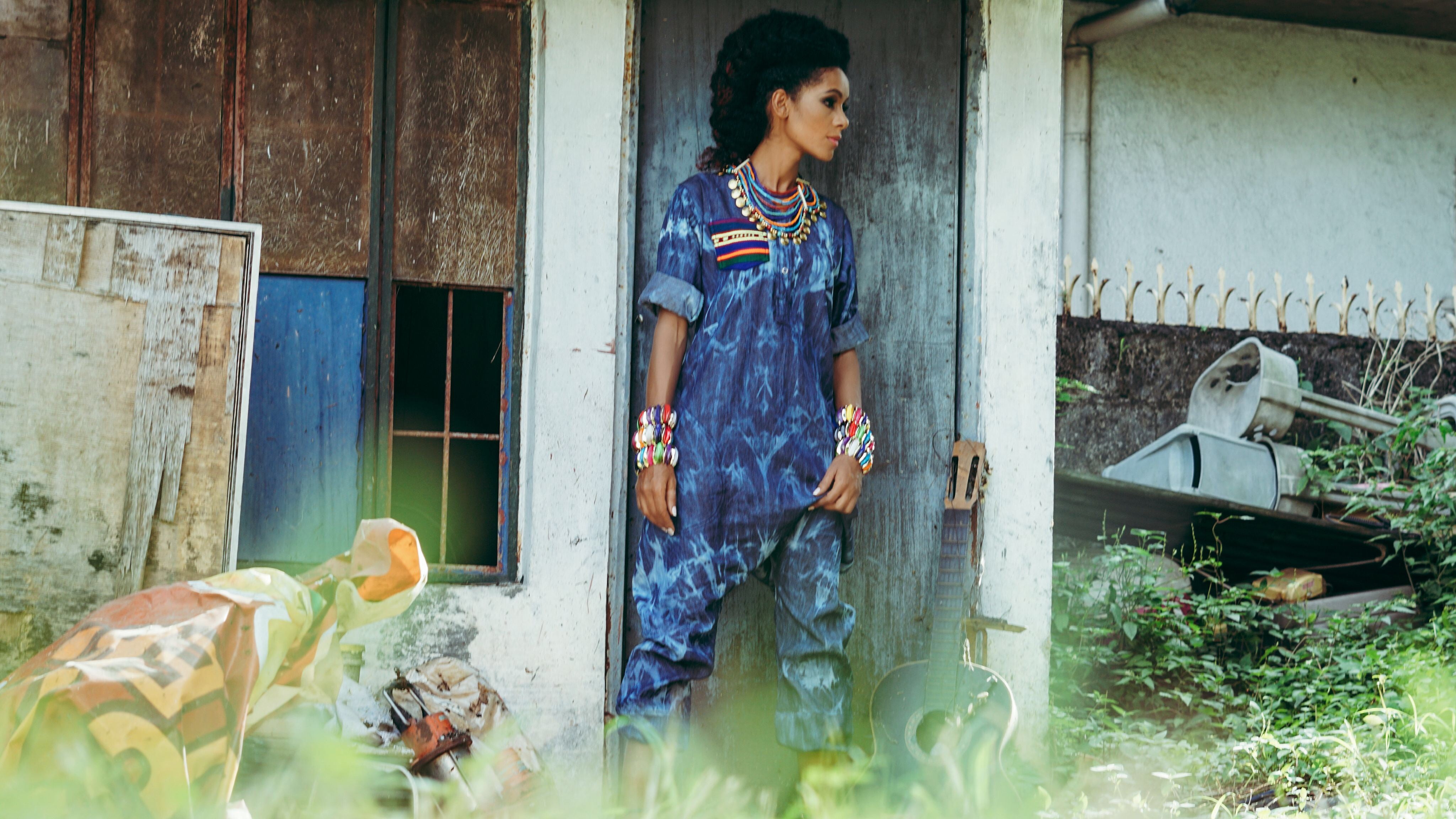 African model in blue denim jumpsuit with colourful accessories