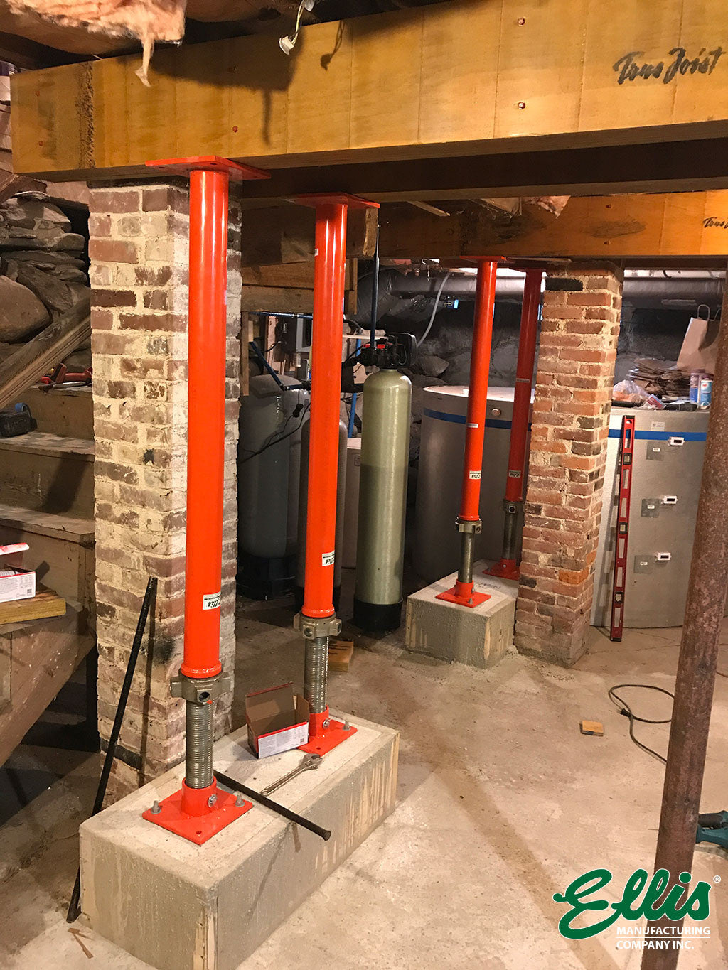 Steel Jack Posts on concrete footers supporting floor beams for leveling