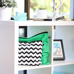 Chevron and green handbags dust covers on shelf