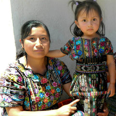 mother and daughter wearing huipiles