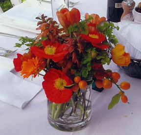 A table centerpiece with orange poppies and zinnias - Renee's Garden