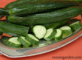 Cucumbers on a plate next to a cucumber sliced into pieces.
