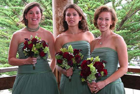 Three bridesmaids wearing sage and holding maroon bouquets. - Renee's Garden