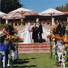 A bride and groom getting married outdoors