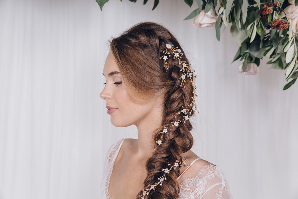 Gold hair vines mixed together to create one bridal plait look