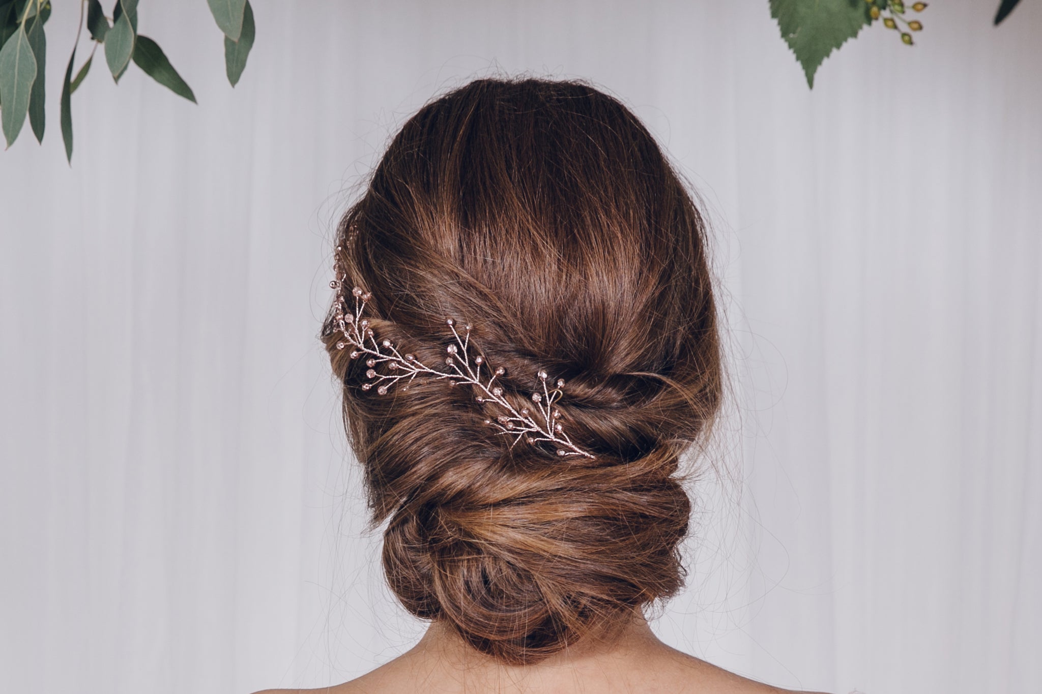 Rose gold rosemary twiggy branch hairvine worn in the back of an updo