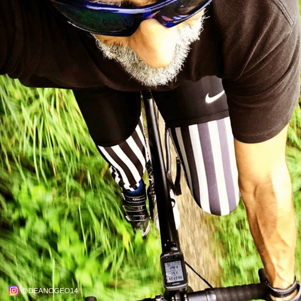 Older man wearing black and white mens tights cycling