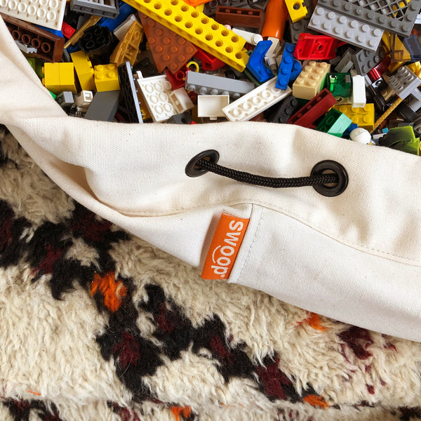 detail of canvas swoop bag with legos