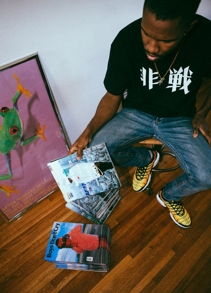 Frank Ocean posing with 2 versions of his Boys Don't Cry magazine 