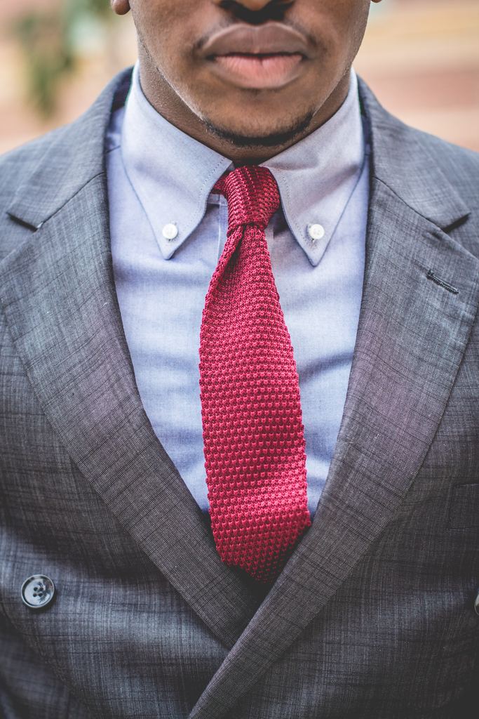 Red tie, blue dress shirt, charcoal suit